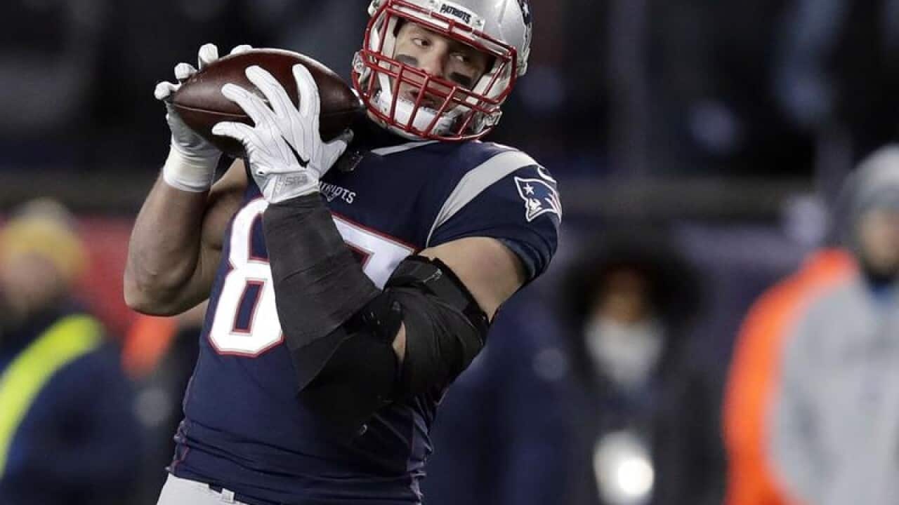 Rob Gronkowsk catches a pass during a game.