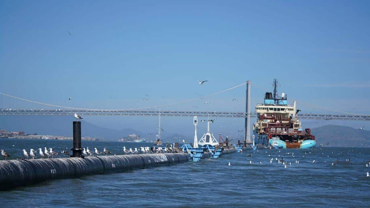 The Ocean Cleanup ship sails underneath the Golden Gate Bridge on route to the largest accumulation of plastic in the world.