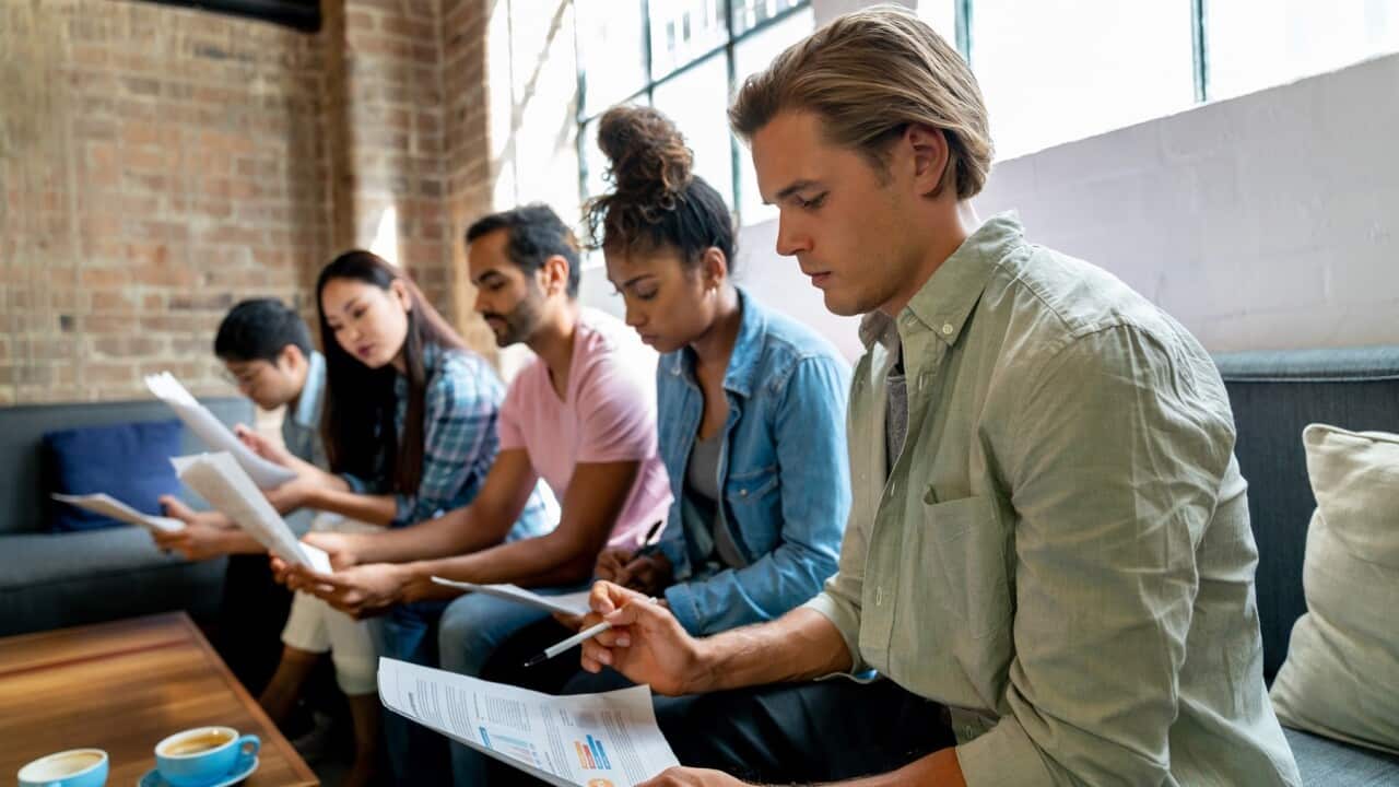 People waiting in an office waiting for an interview