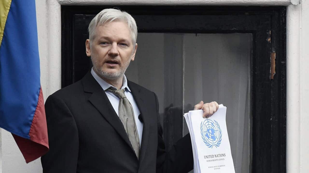 Julian Assange (C) at the Ecuadorian Embassy in London