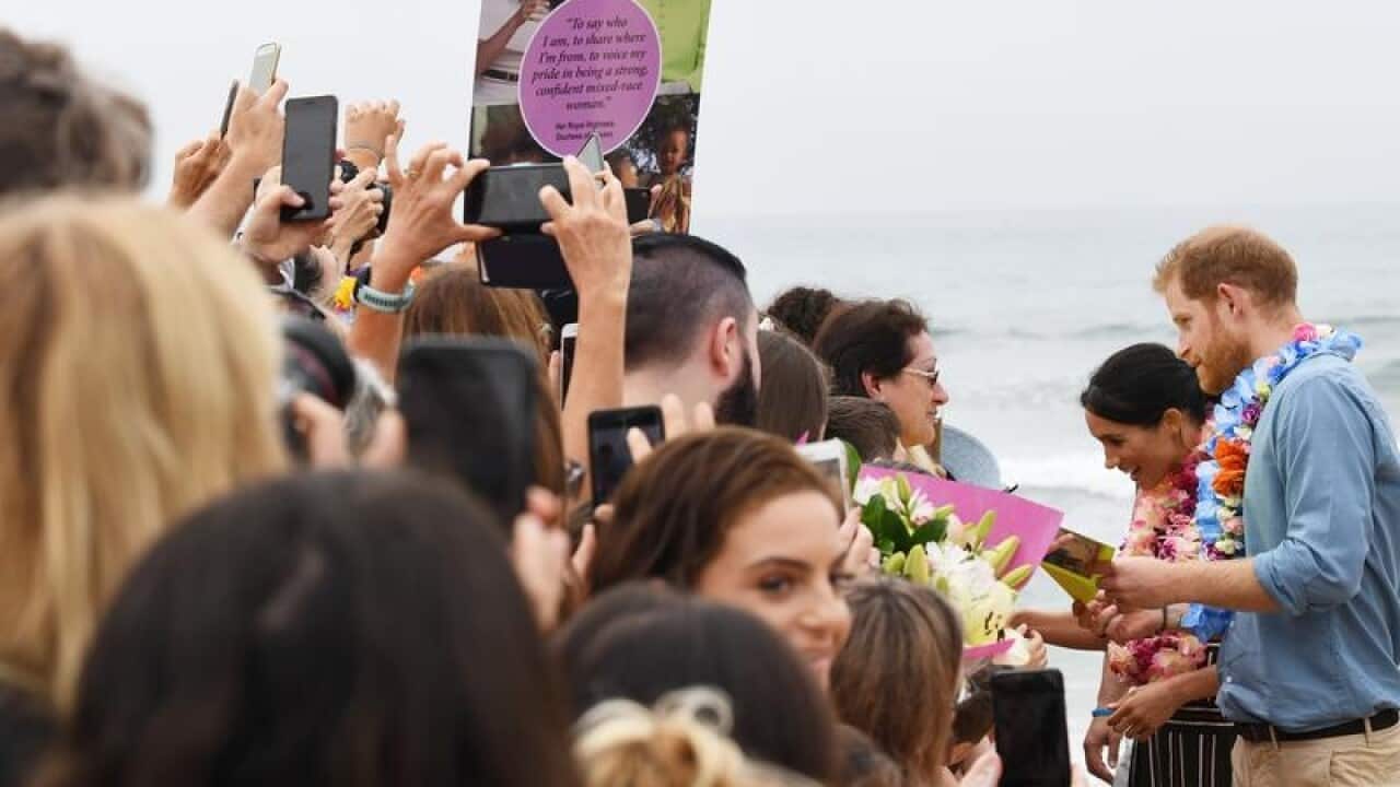 Harry and Meghan meeting people during a walkabout at Bondi Beach.