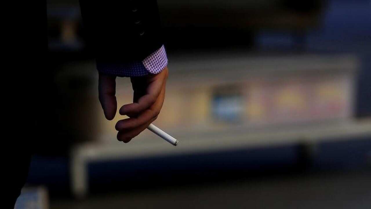 A business man hand holding a cigarette.