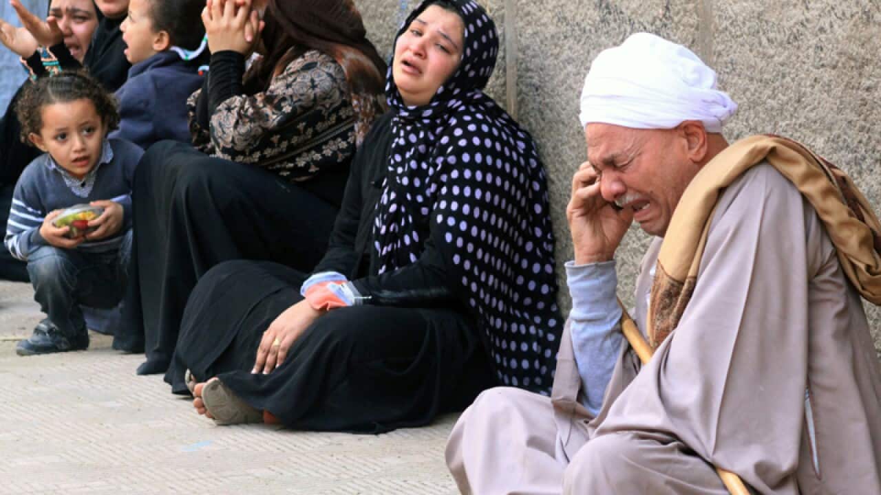 Egyptian relatives of Mohamed Morsi supporters outside the courthouse