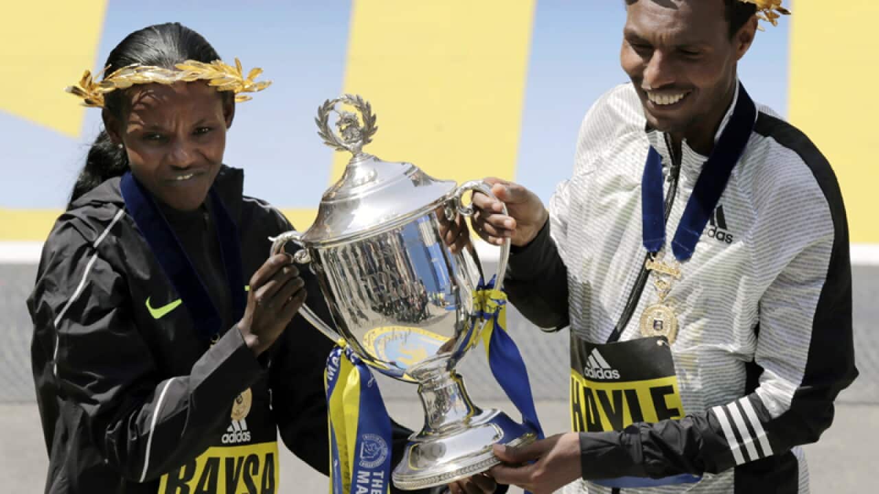 Atsede Baysa (L) and Lemi Berhanu Hayle celebrate in Boston