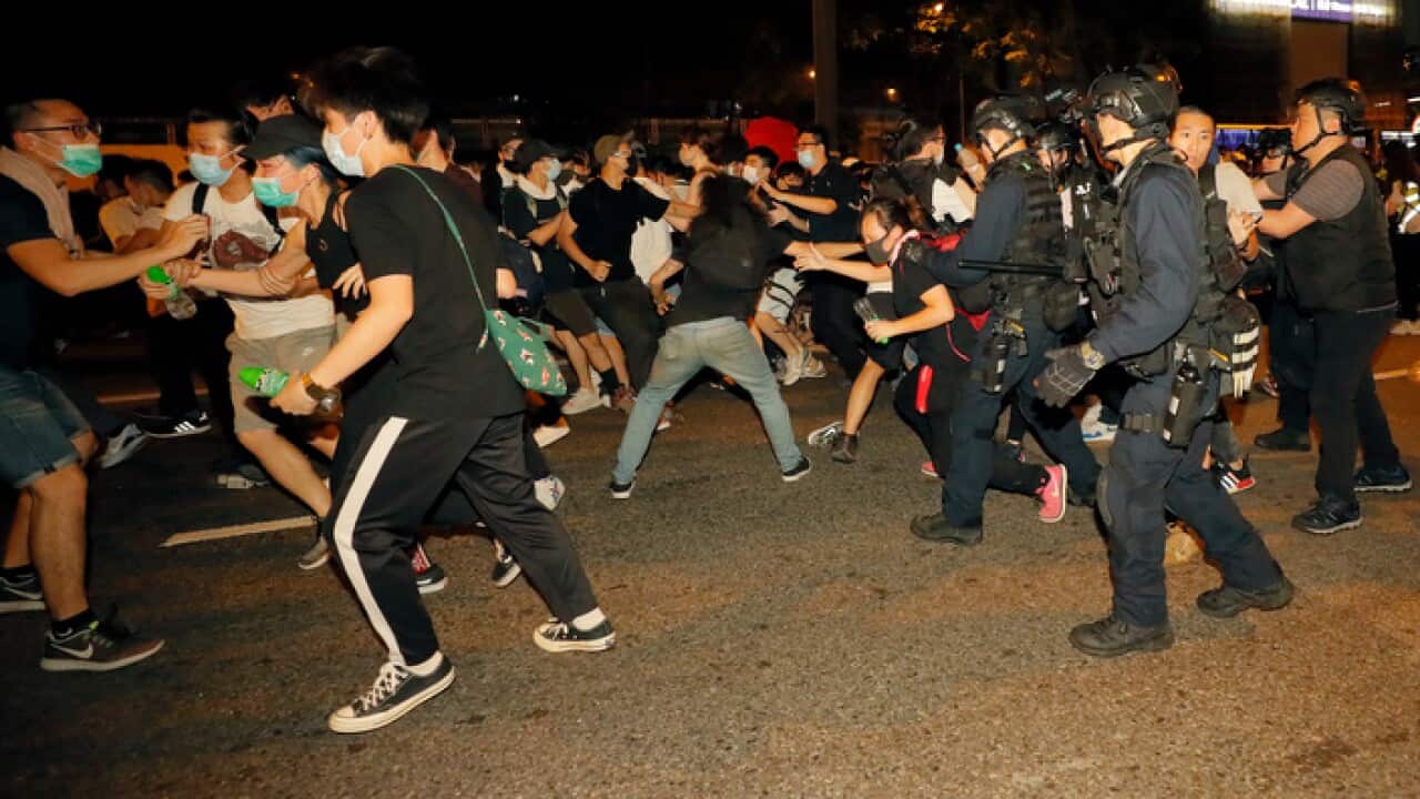 Protesters rallying against the proposed amendments to the extradition law clash with police officers in Hong Kong