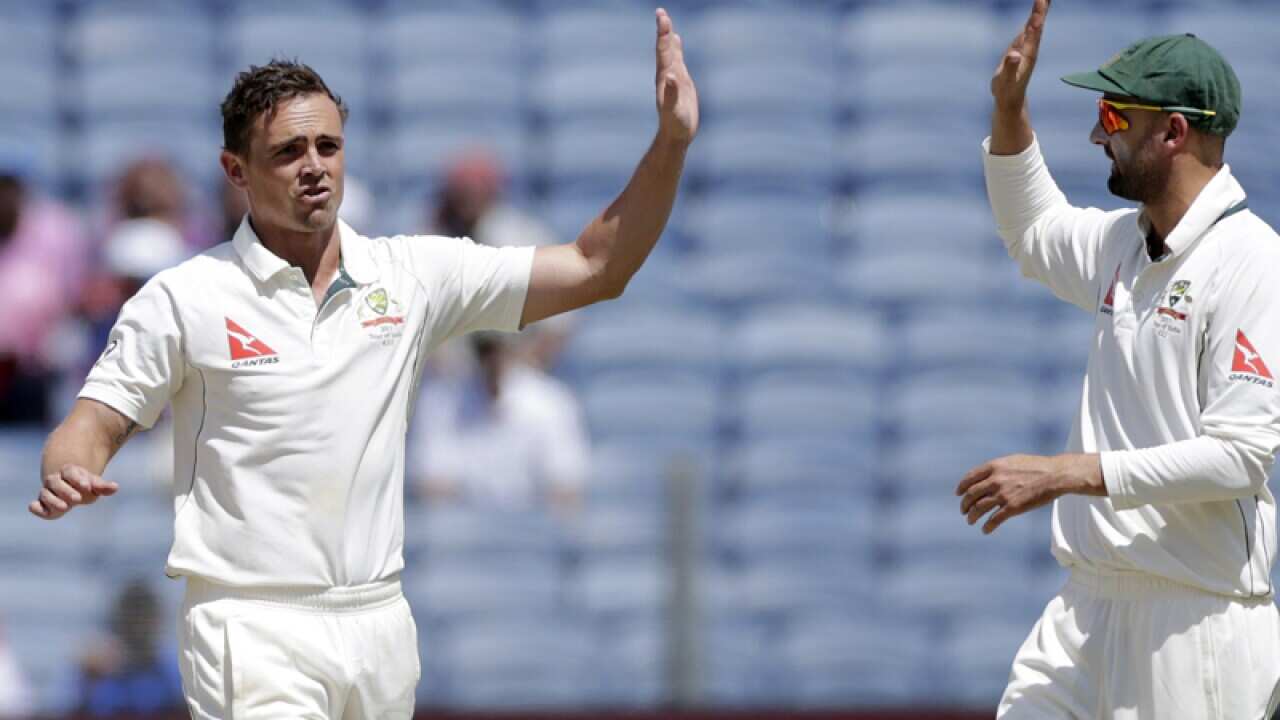 Australia's Steve O'Keefe, left, and Nathan Lyon celebrate