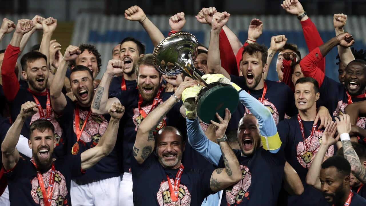 Players of Red Star and head coach Dejan Stankovic (C) celebrate with the trophy after winning the Serbian Cup final soccer match Red Star vs Partizan in Belgrade, Serbia, 25 May 2021