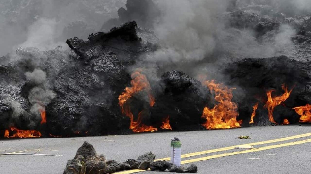 Lava from Hawaii's Kilauea volcano flows across a road.