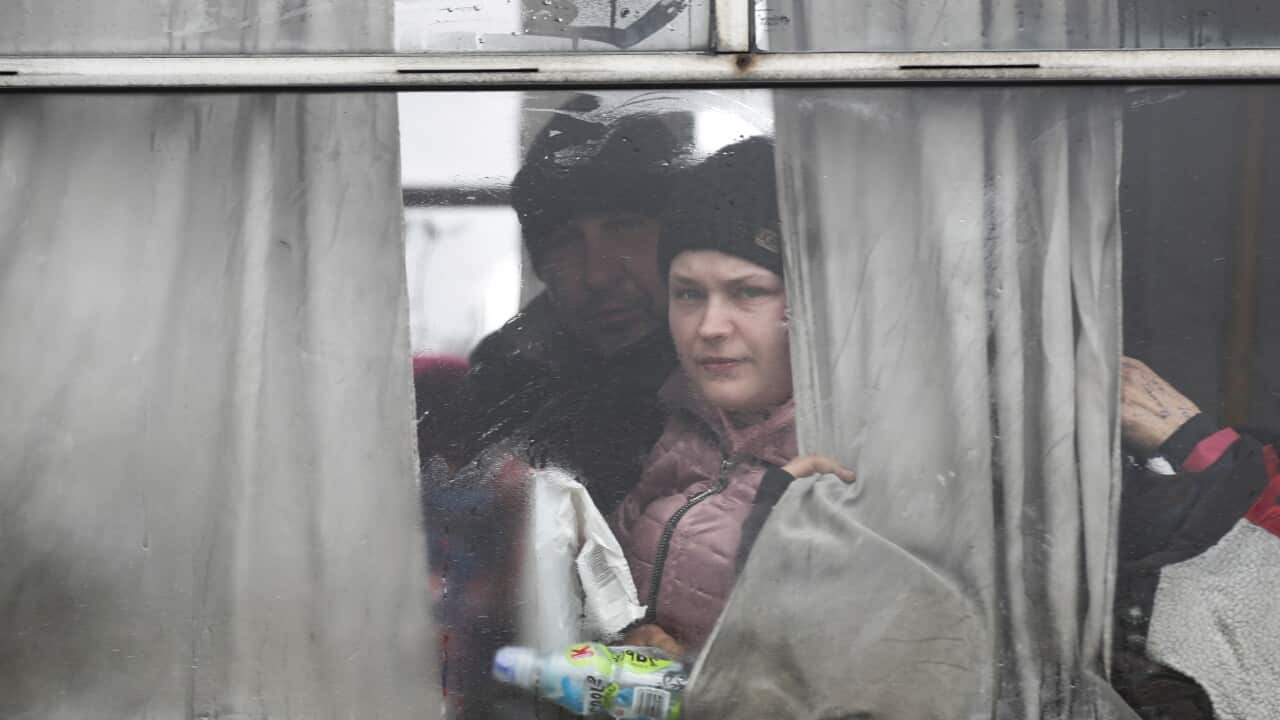 Ukrainian refugees look out from a bus as the leave the city of Bucha, Ukraine, 03 April 2022.