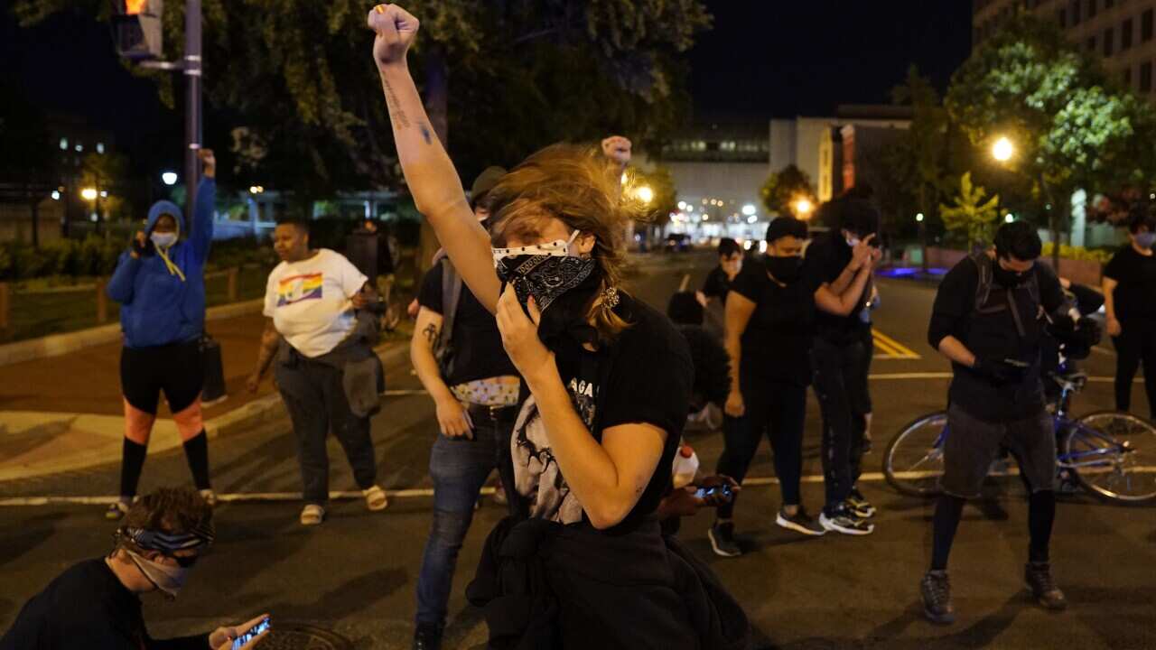 A helicopter circles low as demonstrators gather to protest the death of George Floyd, Monday, June 1, 2020, near the White House in Washington. Floyd died after being restrained by Minneapolis police officers. (AP Photo/Evan Vucci)