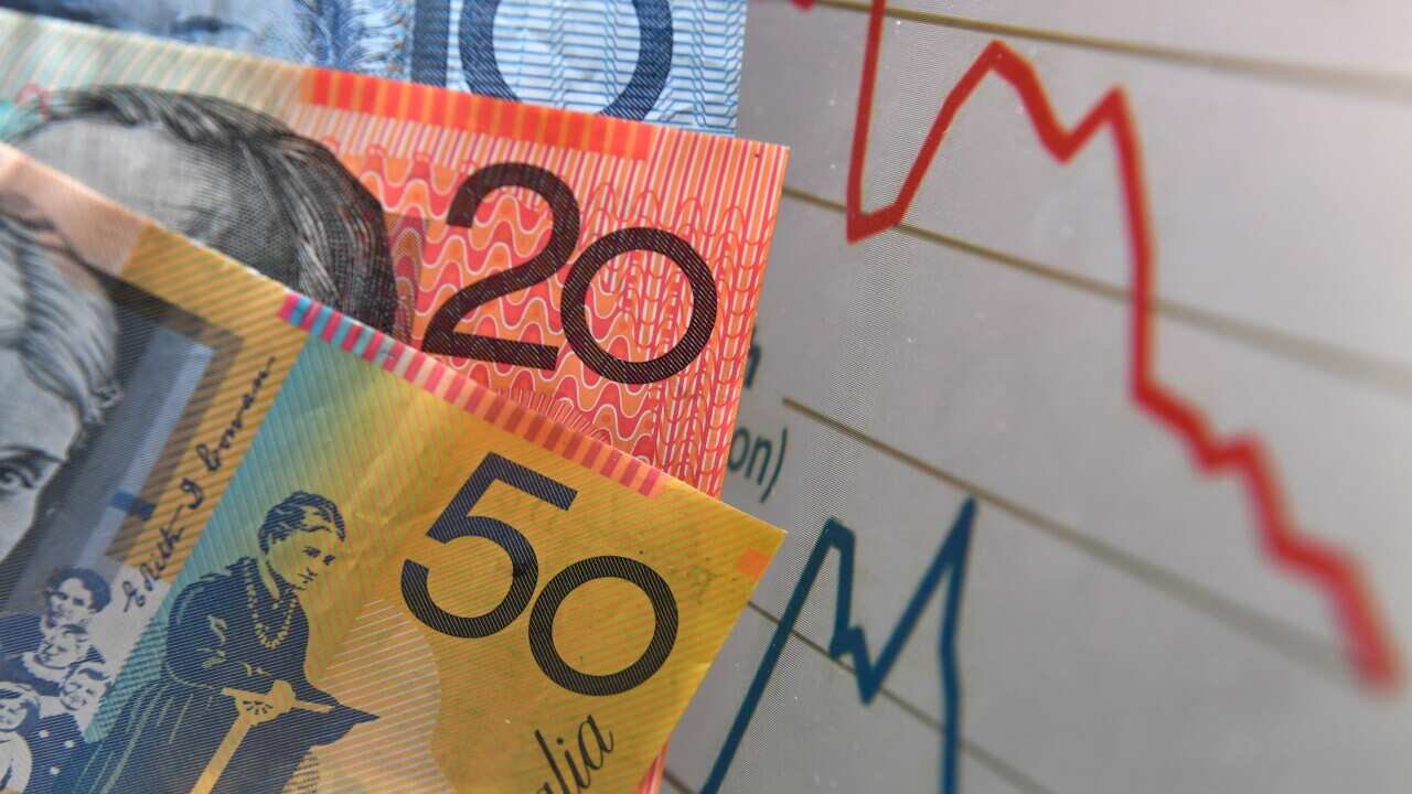Australian currency is seen next to a wages graph