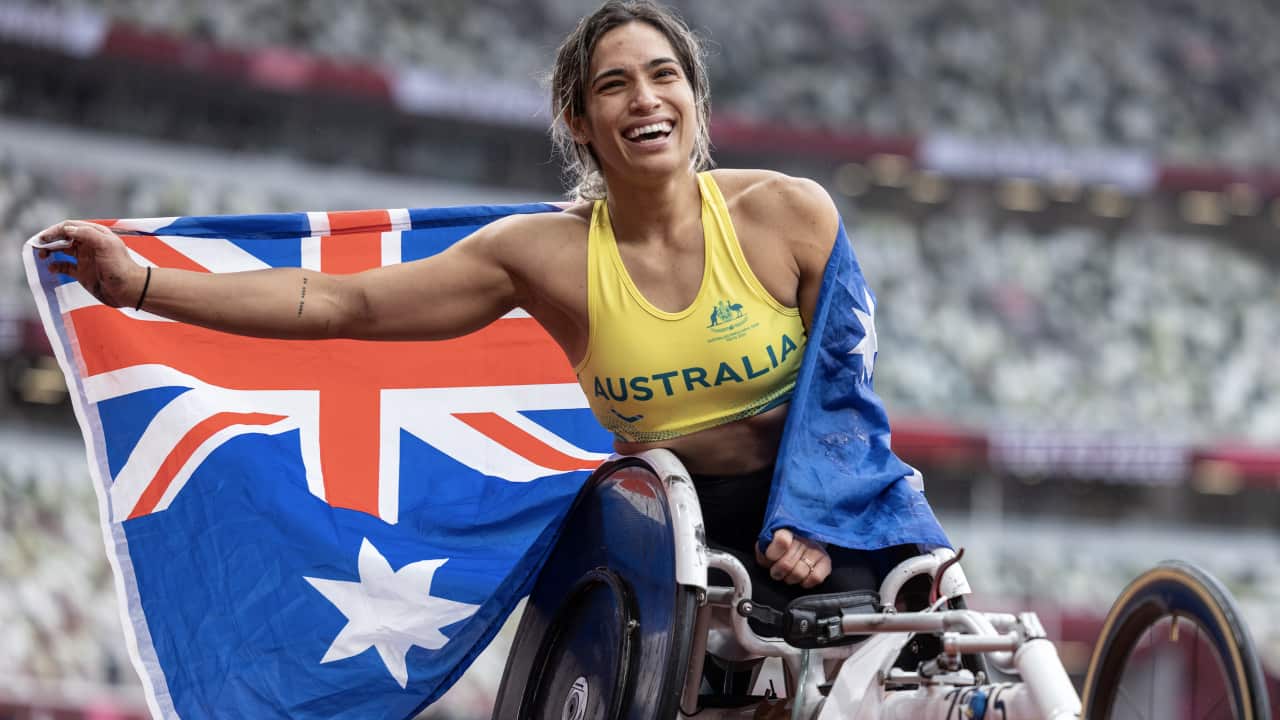 Madison De Rozario of Australia celebrates her win in the Women’s Marathon T54 Athletics Final starting at the Olympic Stadium during the Tokyo Paralympics.