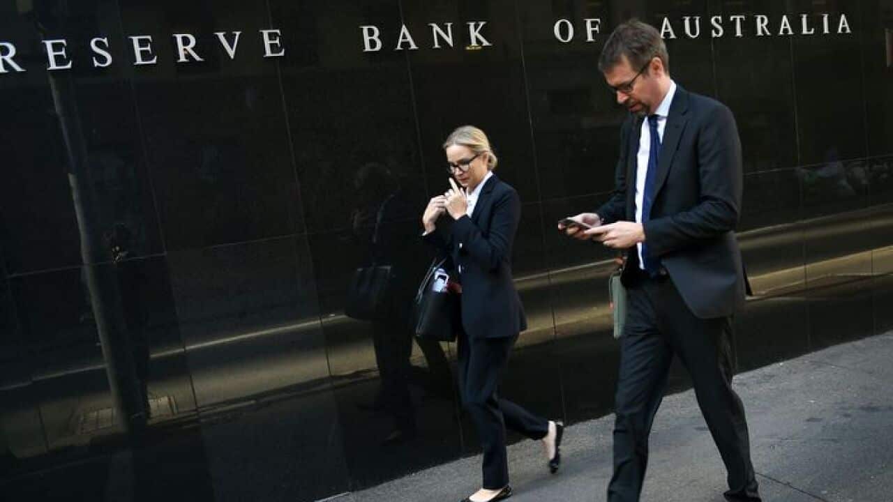 People walk past the Reserve Bank of Australia building