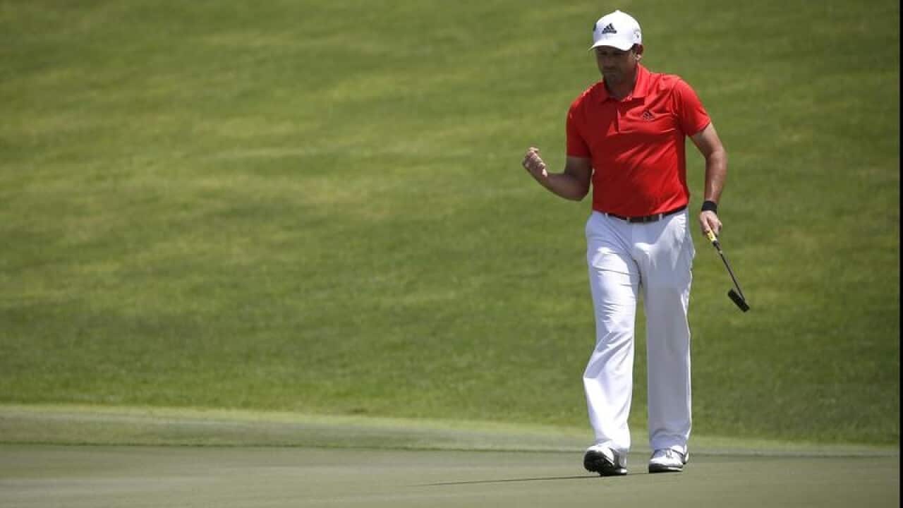 Sergio Garcia of Spain reacts after sinking his putt.