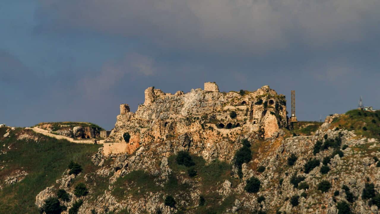 A castle on top of a rocky mountain
