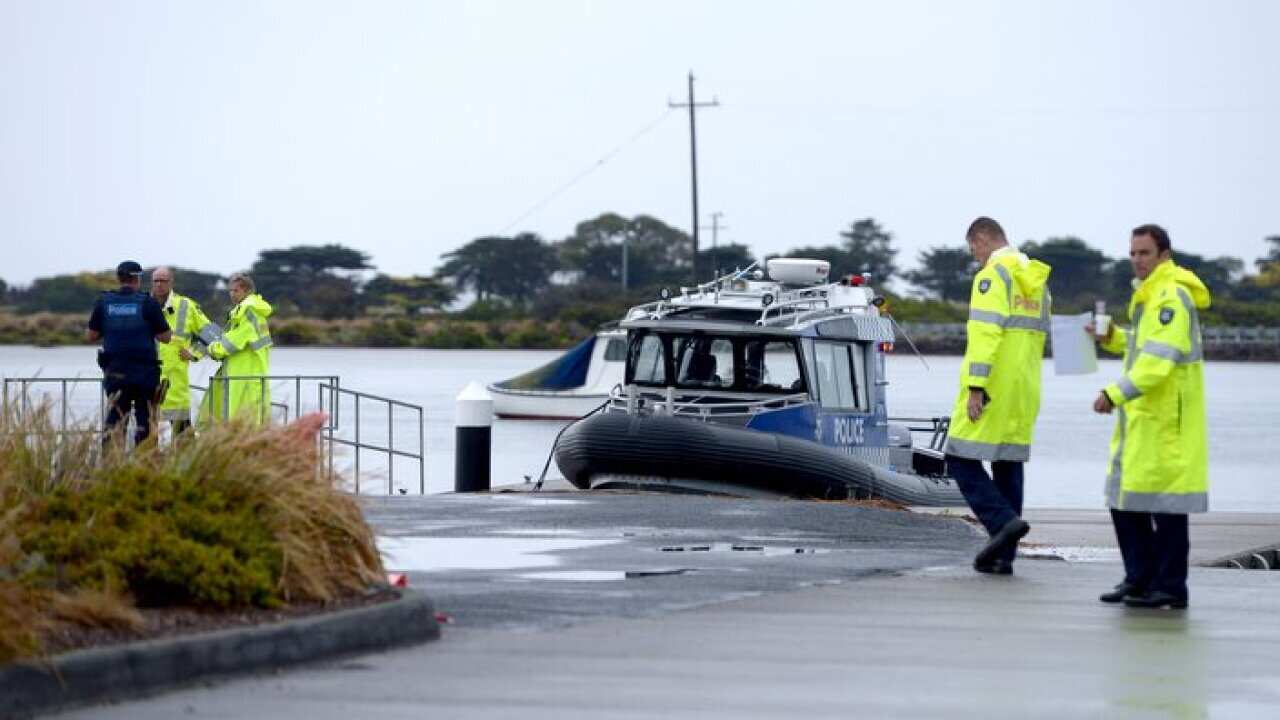 A Victorian Police boat is seen docked at Point Lonsdale following a plane crash at Barwon Heads in Victoria. AAP Image/Mal Fairclough)