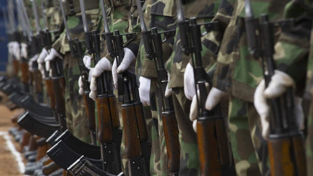 South Sudan soldiers stand guard ahead of being reviewed