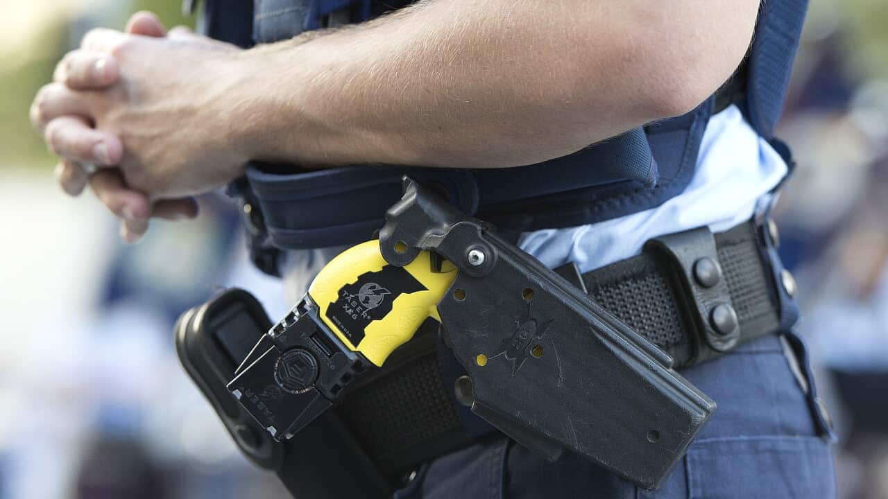 Stock photograph of a Queensland Police Officer wearing a Taser in the Brisbane CBD, Friday, Feb. 28, 2014. (AAP Image/Dave Hunt) NO ARCHIVING