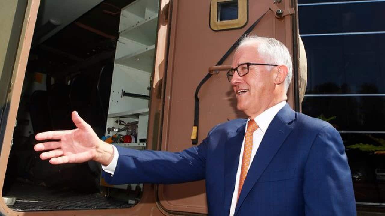 Prime Minister Malcolm Turnbull inspects the military truck Bushmaster during a visit to Thales Underwater Systems in Sydney, Monday, January 29, 2018. The Turnbull government has unveiled a new plan to boost Australian defence exports with an aim to move