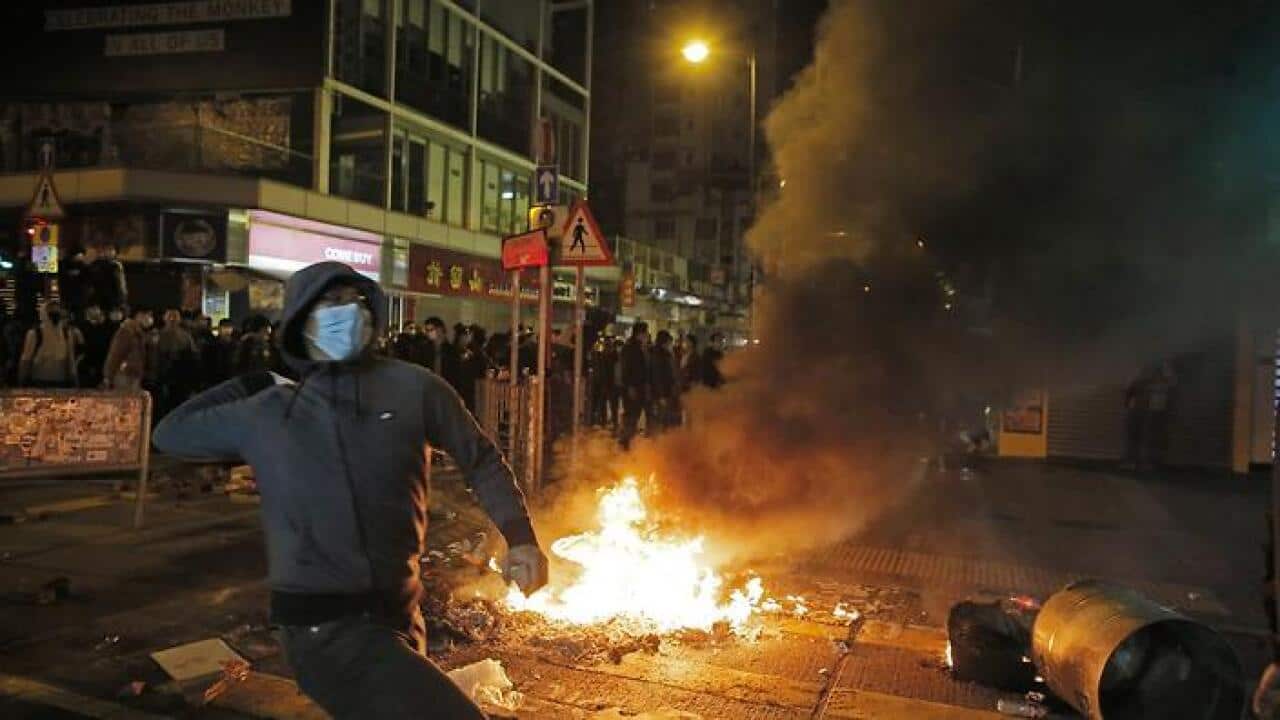Rioters lit fires and throw bricks at police in Mong Kok district of Hong Kong, Tuesday, Feb. 9, 2016. (AAP)