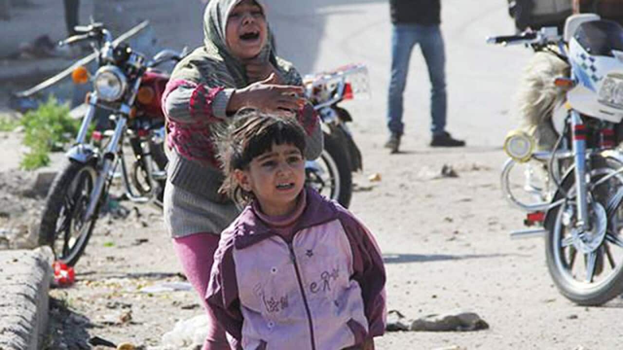 Syrian girls reacting after a government airstrike attack.