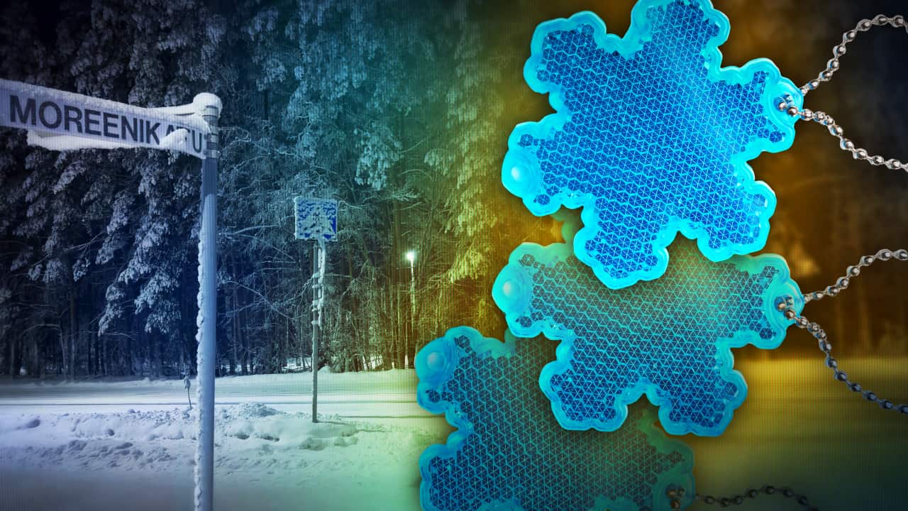 A composite image of a road sign covered in snow with an image of snowflake-shaped reflectors over the top.