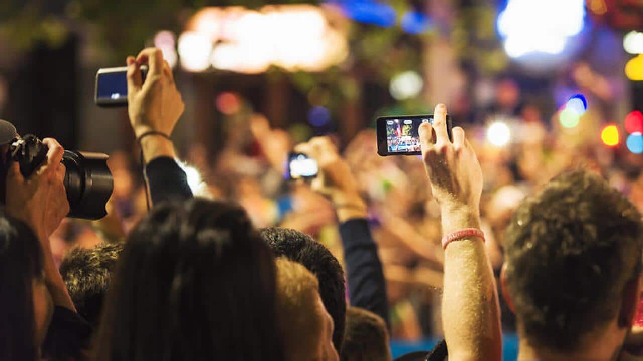 Spectators Photographing an Event