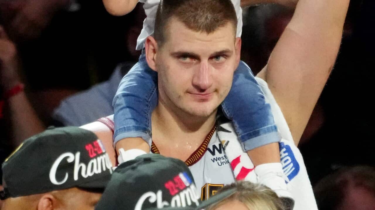 A man with a child on his shoulders.