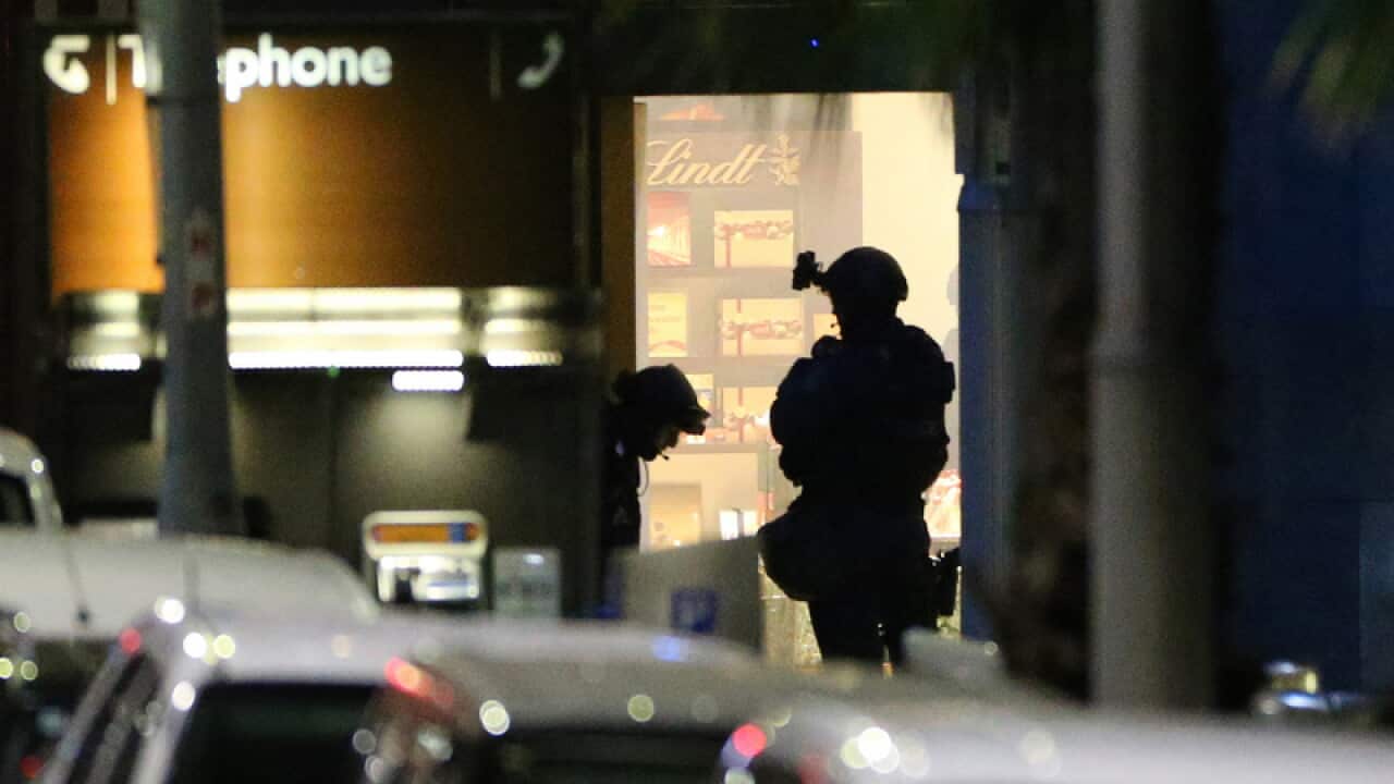 Tactical response officers ready to enter the Lindt cafe during a siege in Sydney