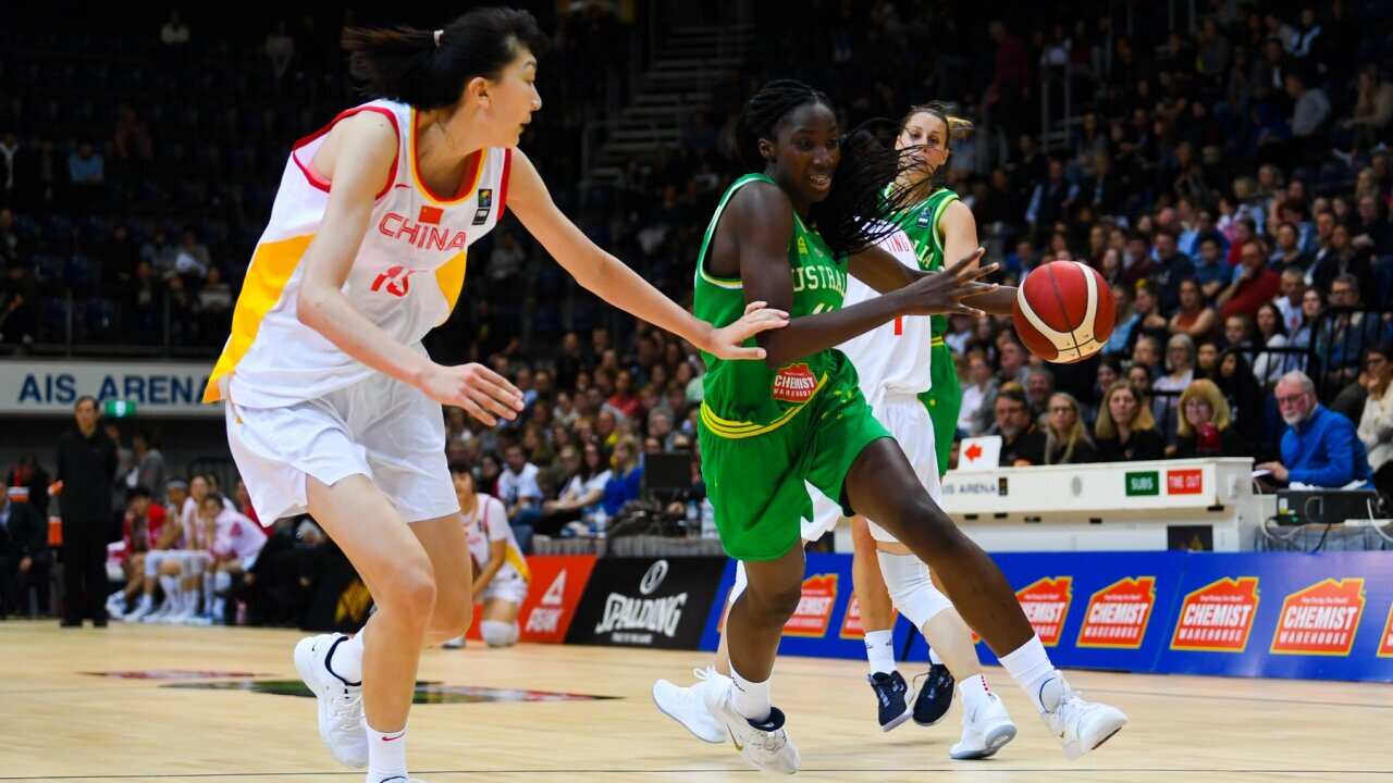 Ezi Magbegor of the Opals (right) fights for the ball with Han Xu of China during a Fiba Asia Cup warm-up match between the Australian Opals and China at the AIS Arena in Canberra, Thursday, September 19, 2019. (AAP Image/Lukas Coch)