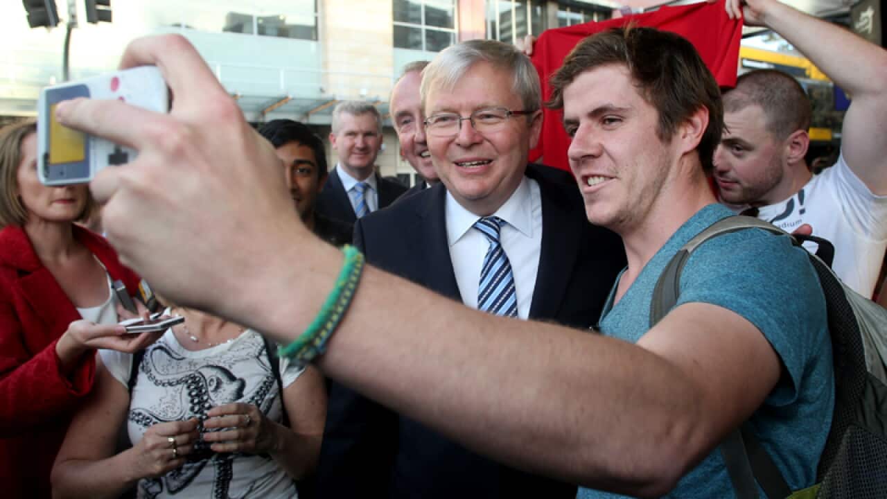 Prime Minister Kevin Rudd (C) poses for a photo with locals in Burwood