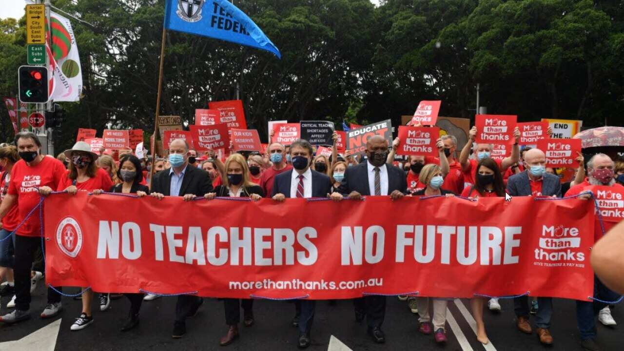 Teachers march on Parliament House during a strike by NSW public school teachers and principals in Sydney, Tuesday, 7 December, 2021.