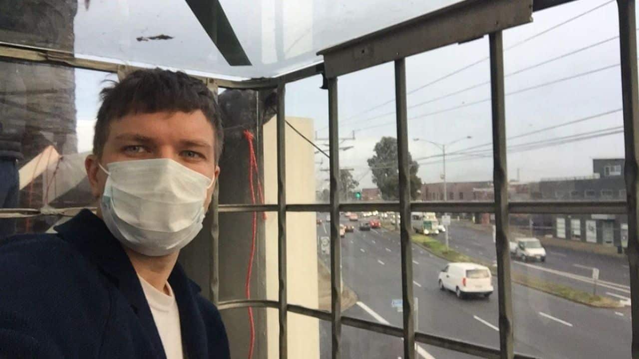 A refugee protester chained himself inside a metal cage on Wednesday morning.