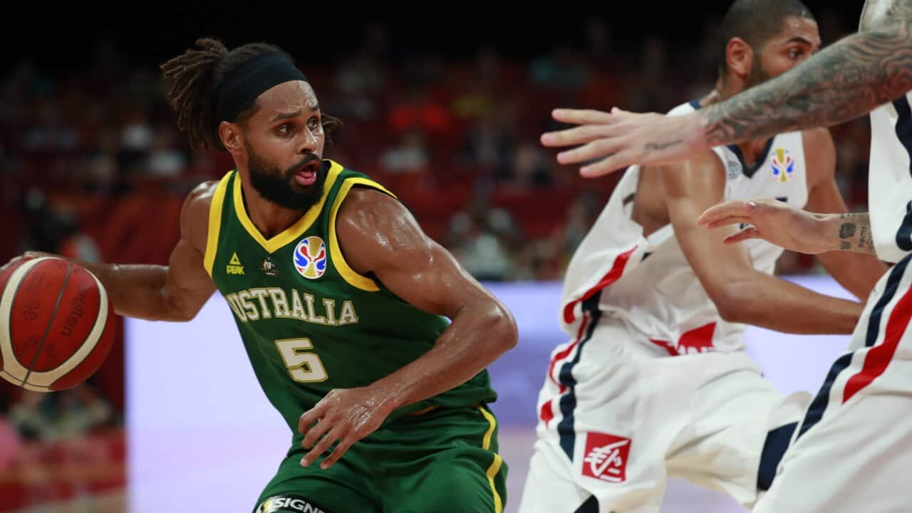 epa07843840 Patty Mills of Australia (L) in action during the FIBA Basketball World Cup 2019 Third Place match between France and Australia in Beijing, China, 15 September 2019. EPA/HOW HWEE YOUNG