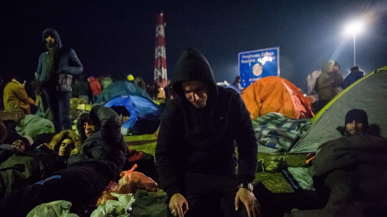 A group of migrants rest at the Serbian village of Kelebia on the border with Hungary