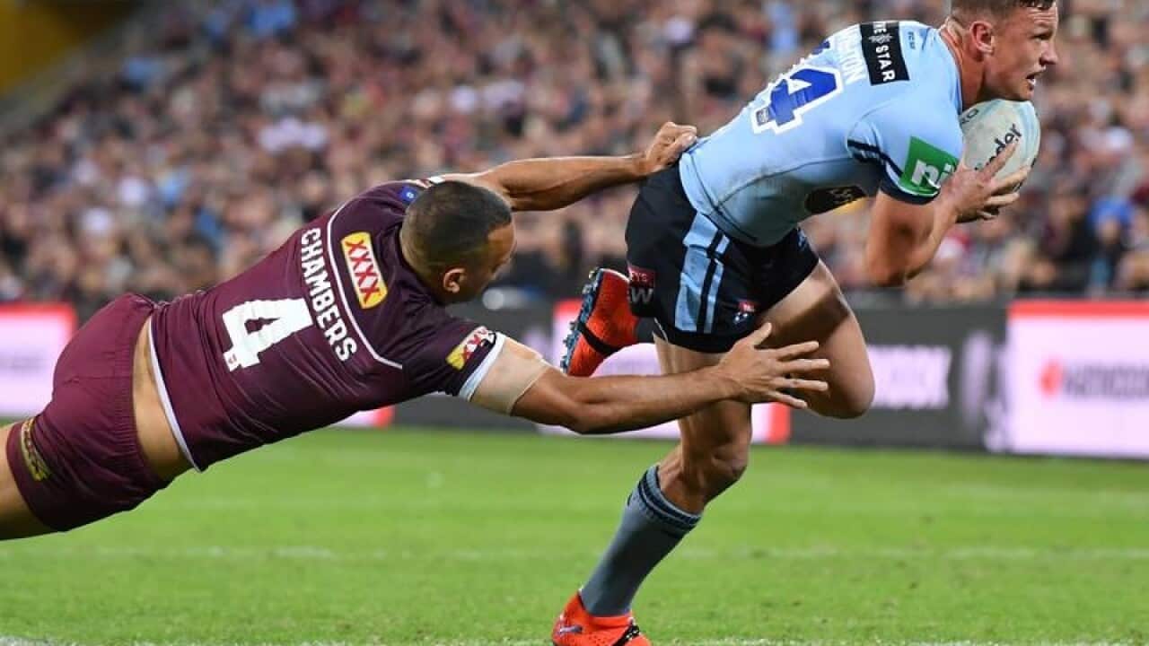 Jack Wighton looks to stride clear of a lunging Will Chambers