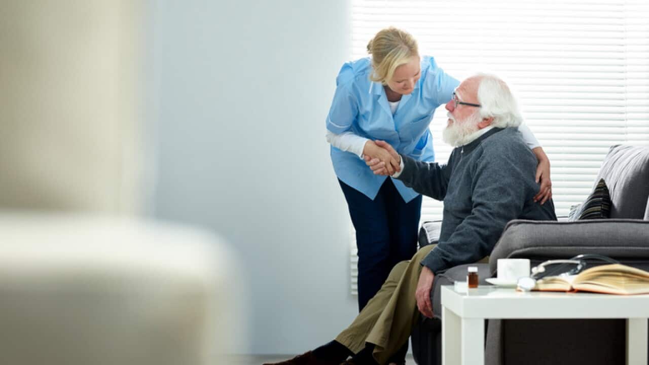 Female caregiver helping senior man