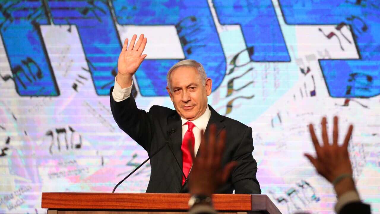 Benjamin Netanyahu waves at his supporters