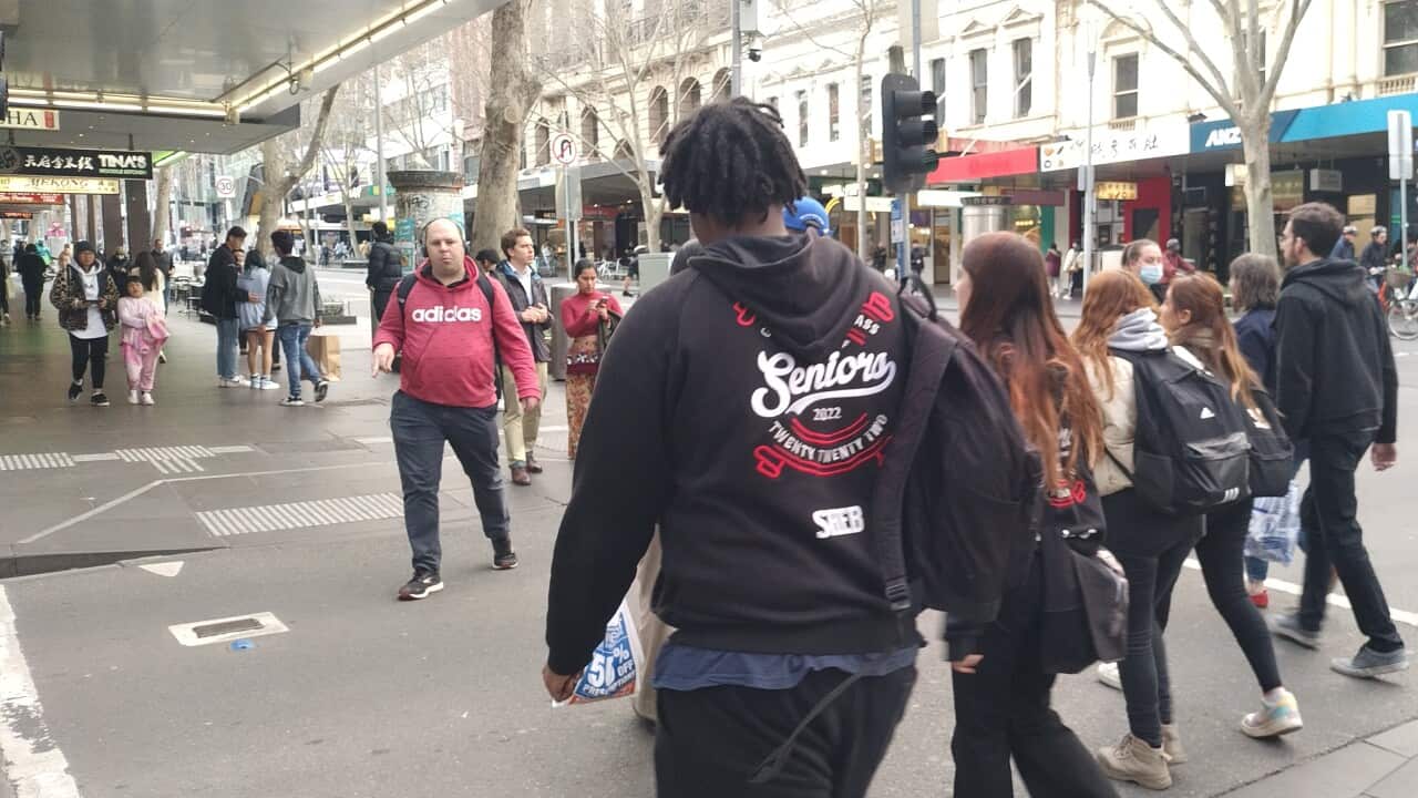 People going about their business in a busy Swanton Street in Melbourne.