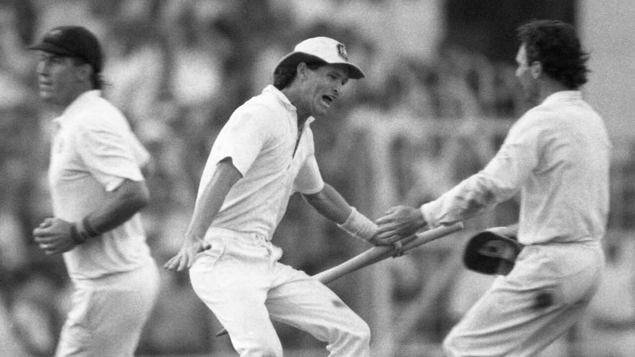 Australian batsman Dean Jones holds the stumps as he races to embrace team captain Allan Border, after Australia won the 1987 Cricket World Cup.