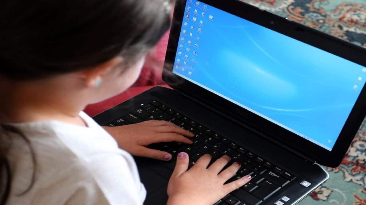 A child using a laptop computer.