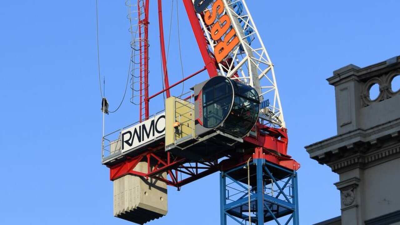 A damaged crane is seen in Richmond, Melbourne, Tuesday, July 24, 2018. Wild winds overnight have impacted the structural integrity of a construction crane, resulting in the evacuation of residents and closure of Bridge road.