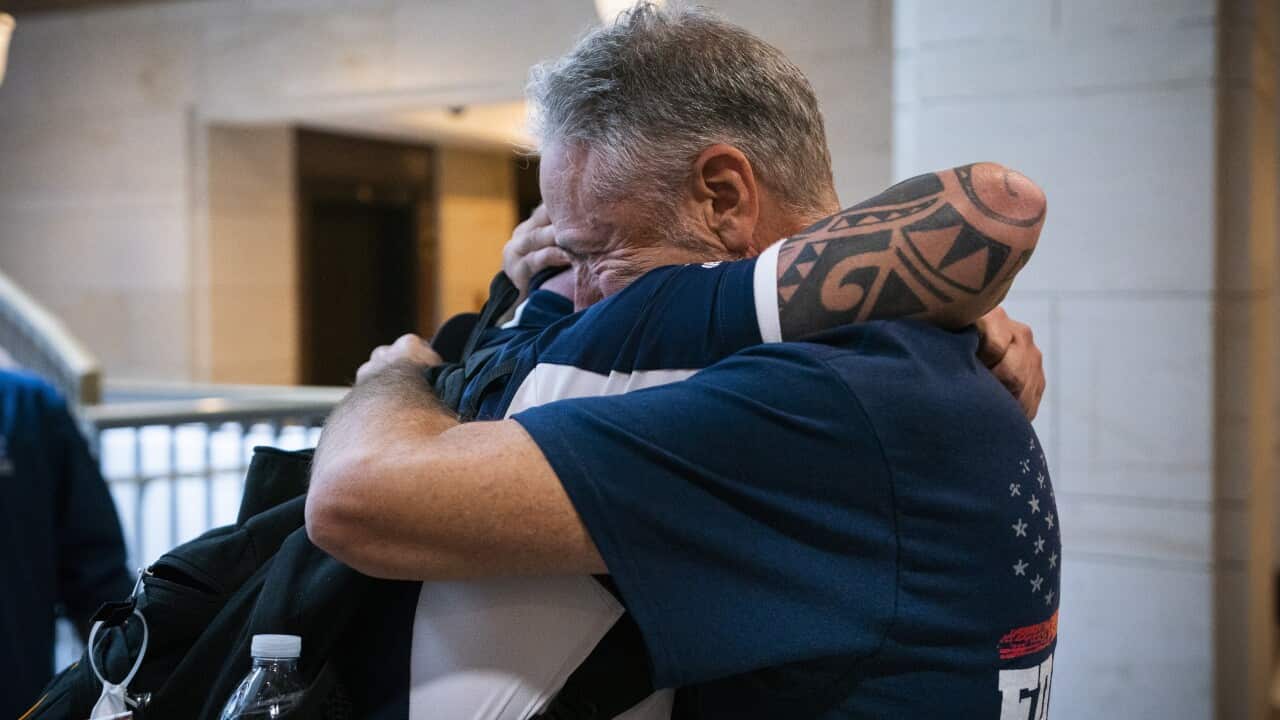 Comedian Jon Stewart hugs 9/11 first responder John Feal after the US Senate's passage of the 9/11 compensation fund.