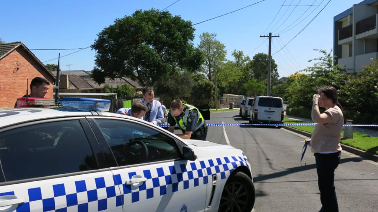 Police and forensic officers cordon off a street in Melbourne