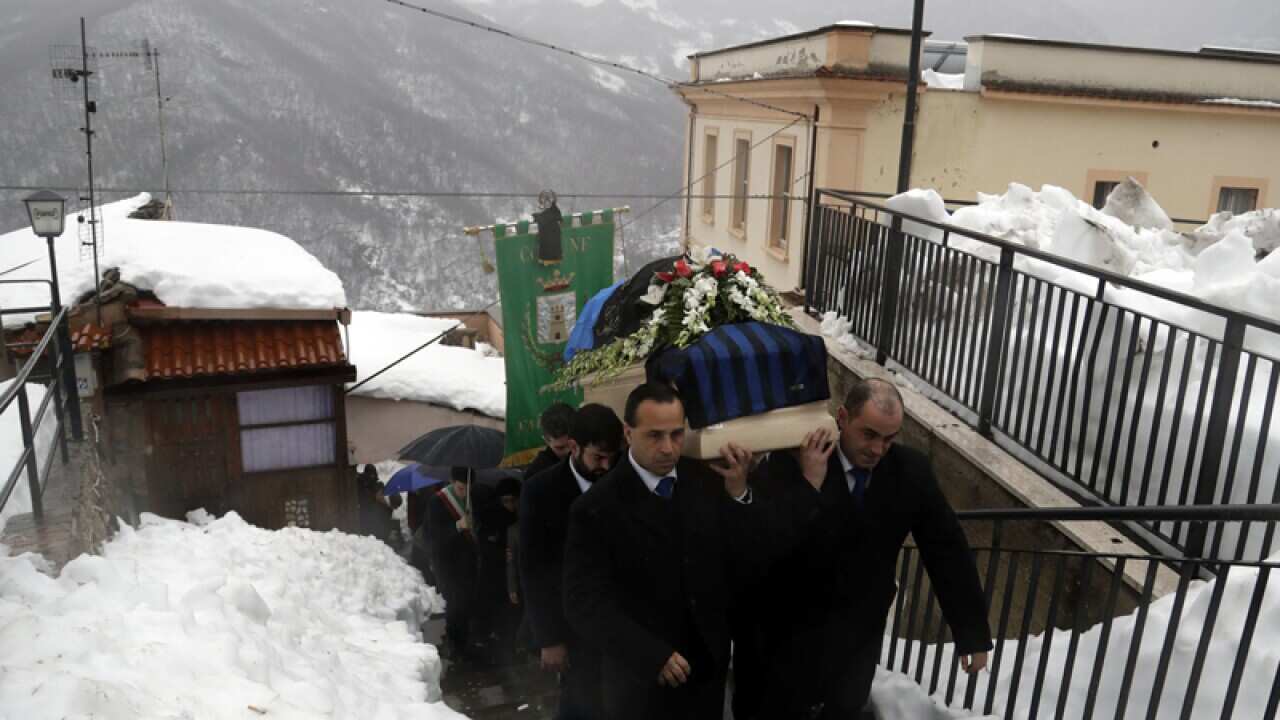 Mourners carry the coffin of a victim of the Italian avalanche