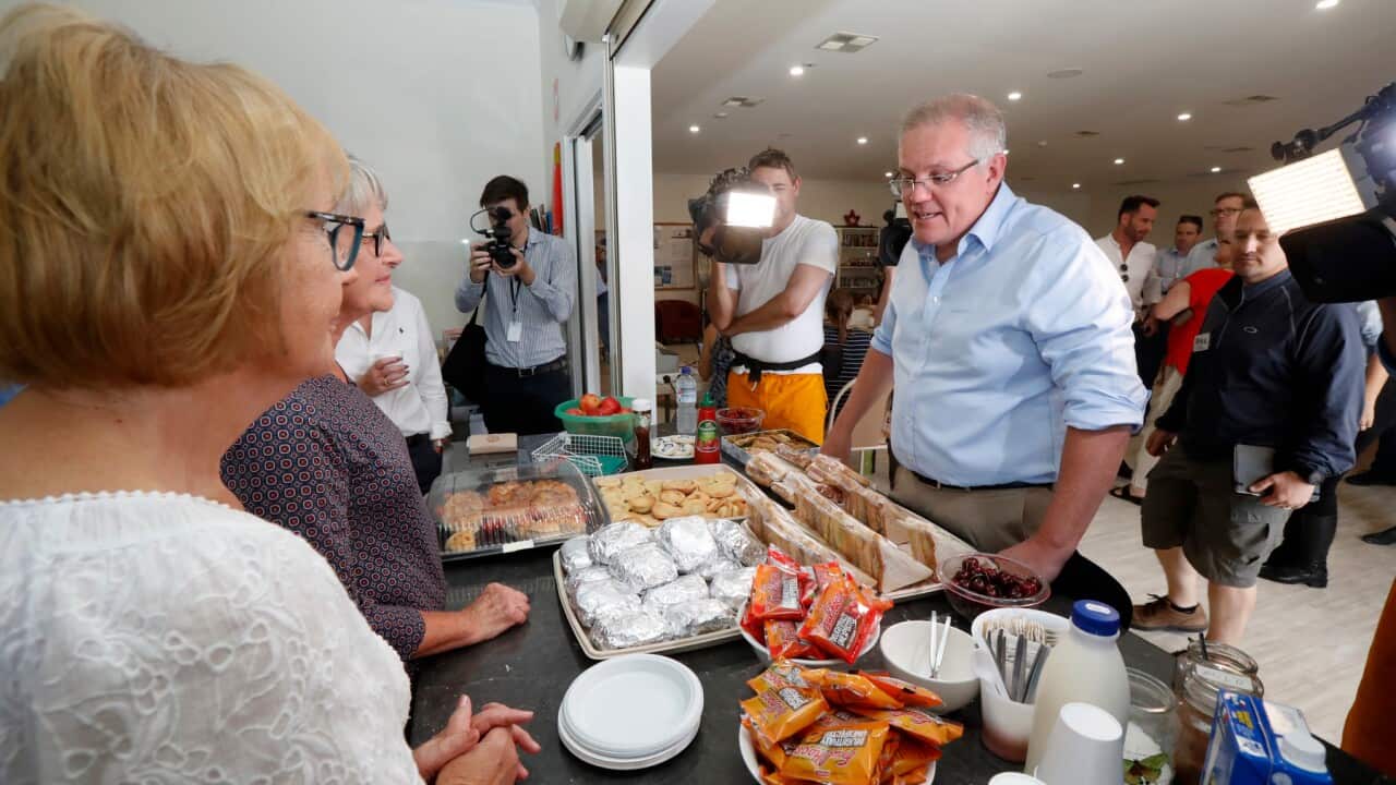 Scott Morrison speaks with volunteers while visiting a relief centre in South Australia