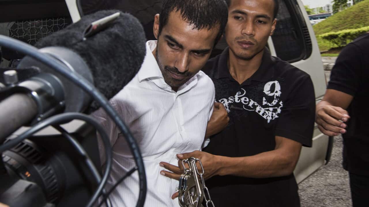 Australian Dominic Bird (L) is escorted to the courthouse Malaysia