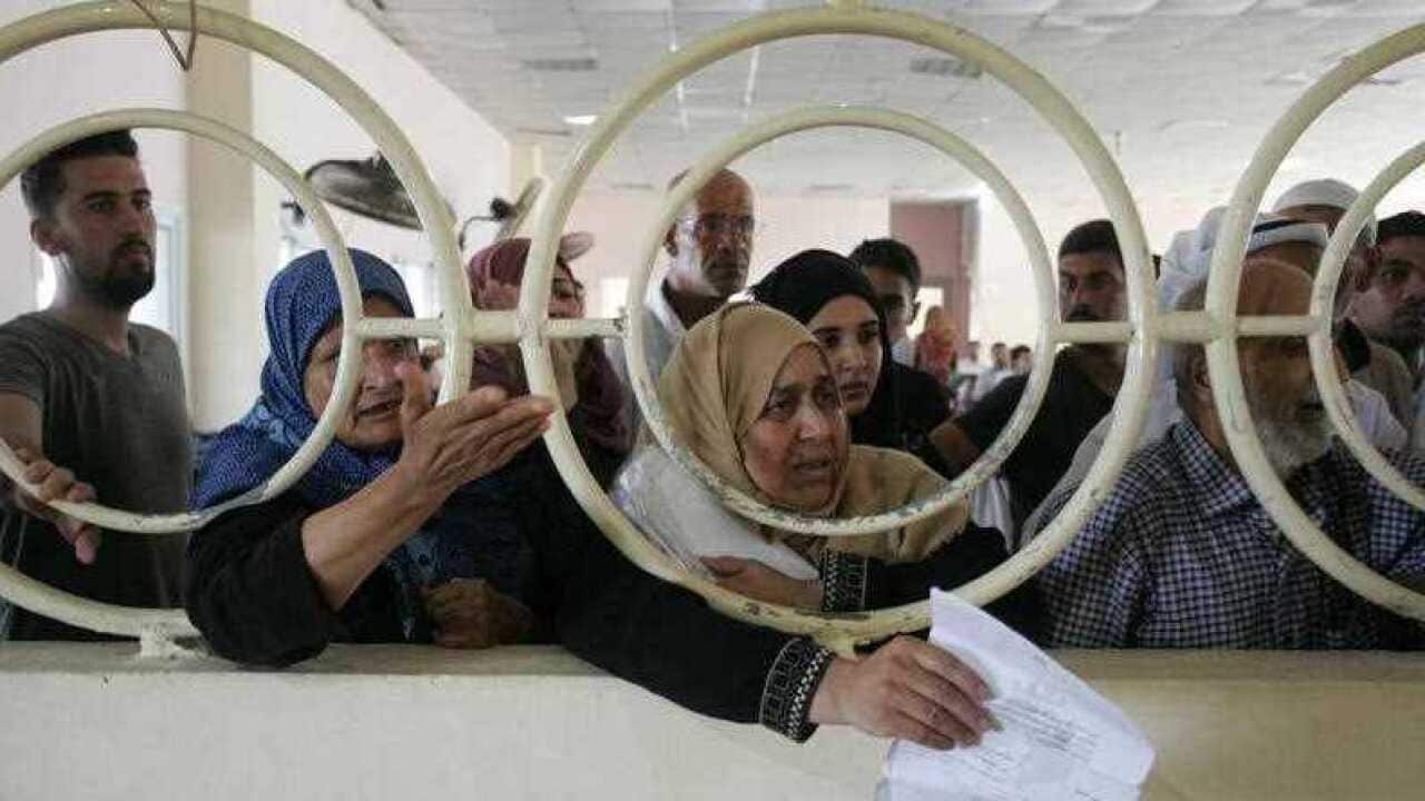 Palestinians wait for travel permits to cross into Egypt