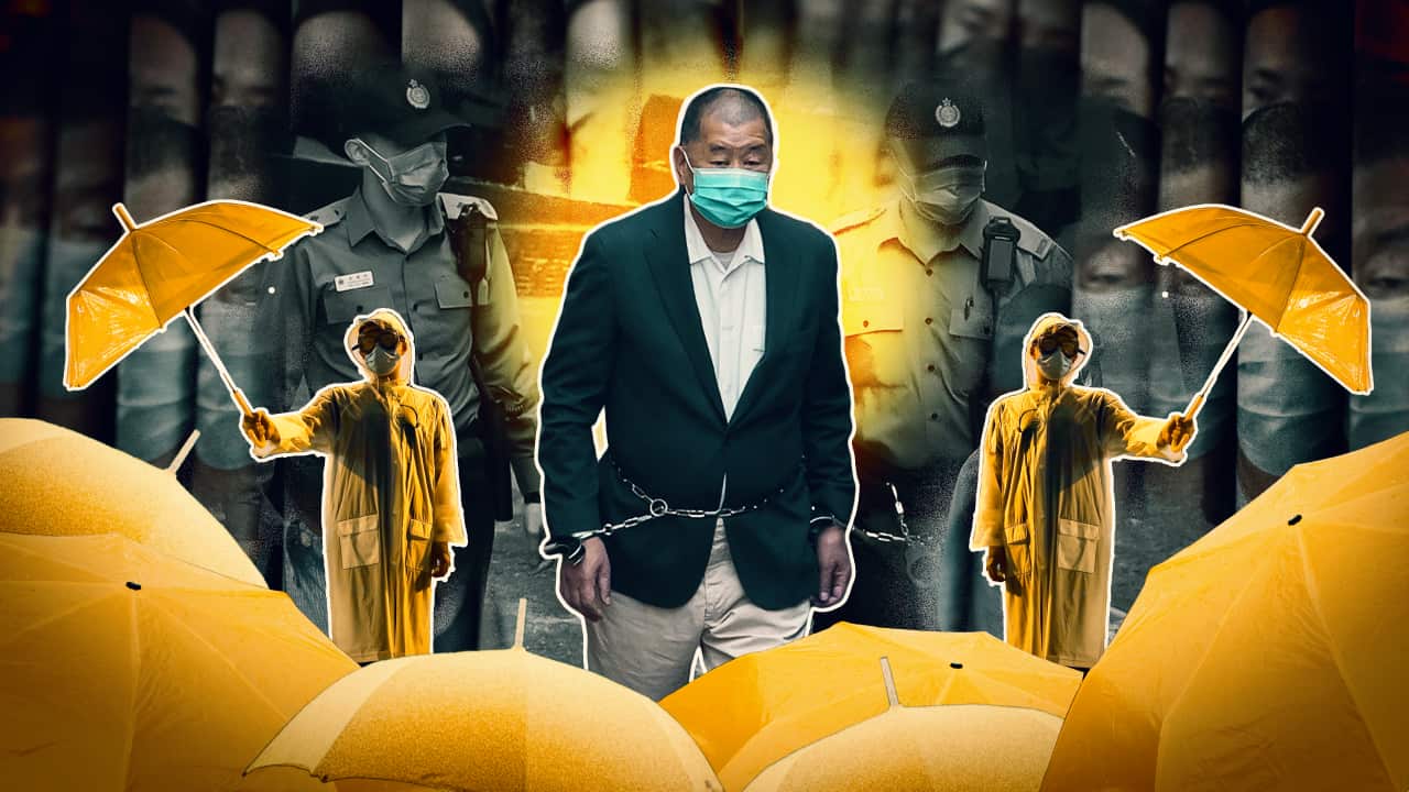 A man in handcuffs and yellow umbrellas.