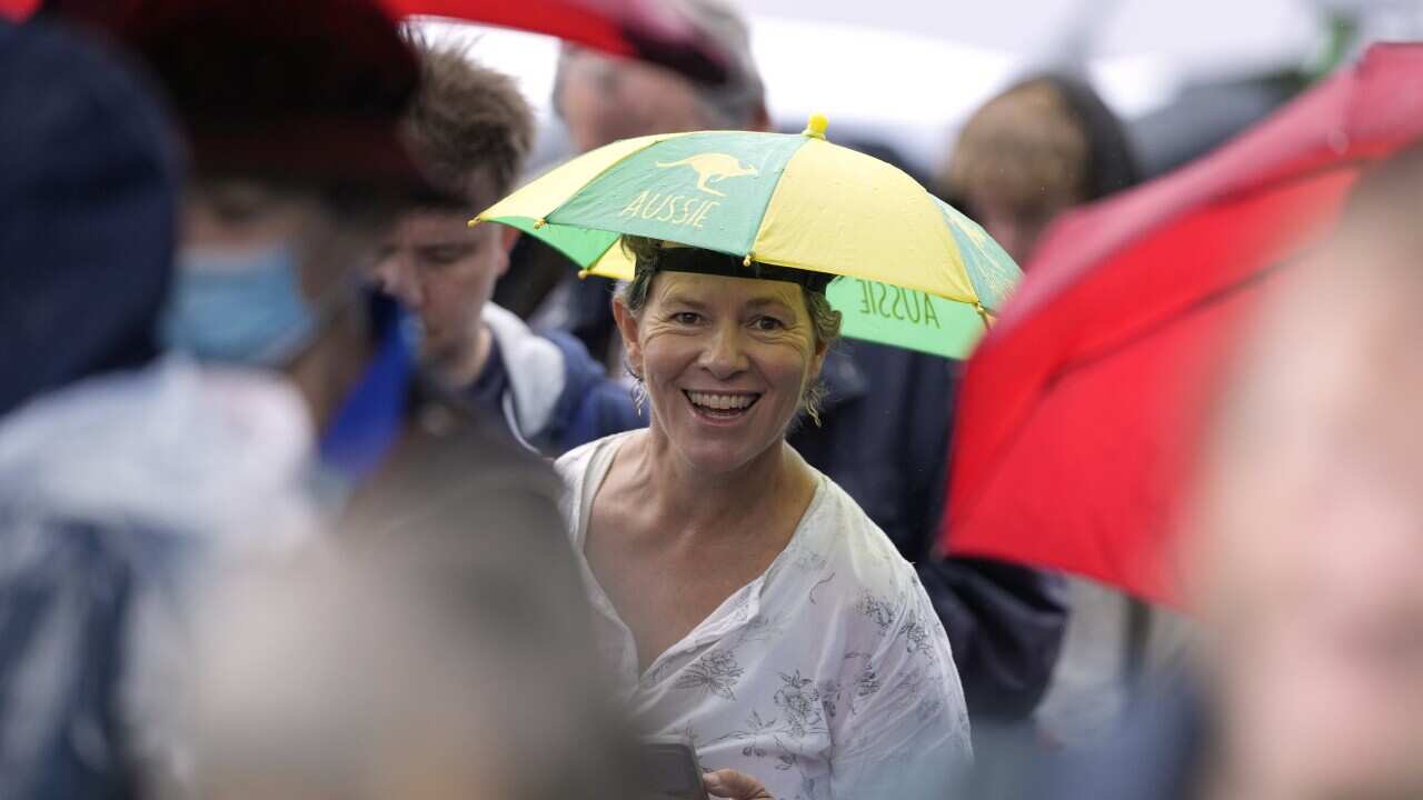 Spectators walk between courts as rain delays the start to the second round matches at the Australian Open 2024 tennis championships at Melbourne Park, Melbourne, Australia.